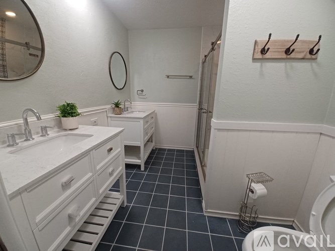 A bathroom with a white sink and a white toilet.
