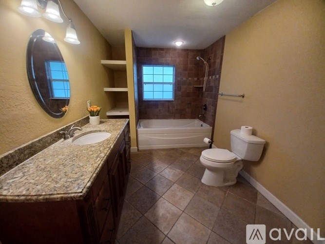 A bathroom with a toilet, sink, and bathtub.