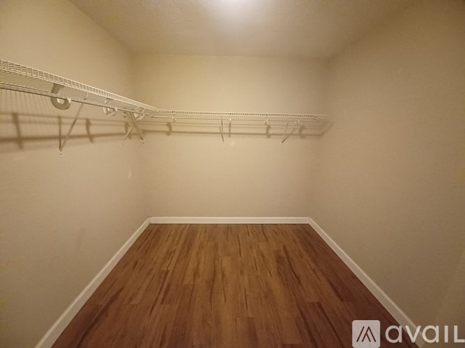 Empty room with wooden floor and white walls.