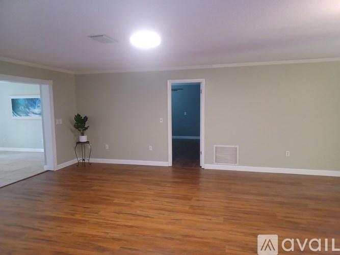 A room with wooden floors and a blue door.