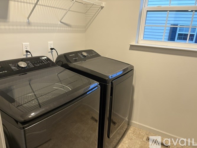 Two front loading washing machines in a laundry room.