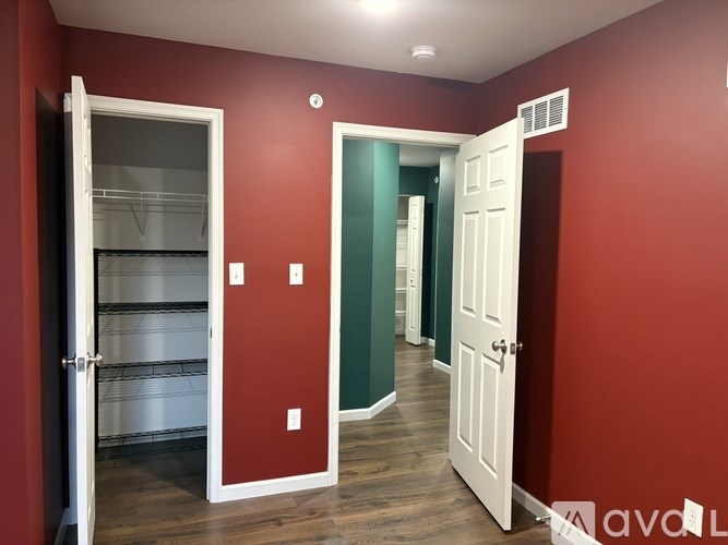 A room with red walls and a white door.