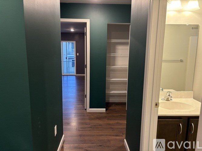 A bathroom with a green wall and a white sink.