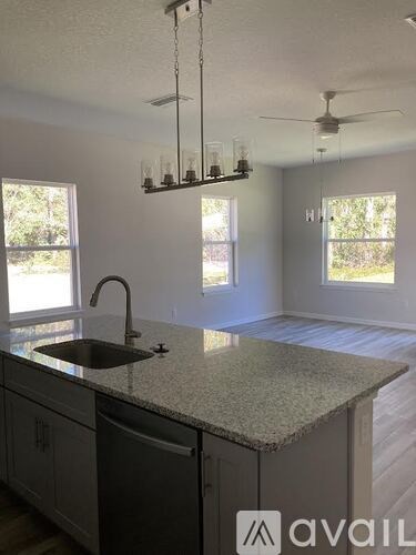 A kitchen with granite countertops and a sink.
