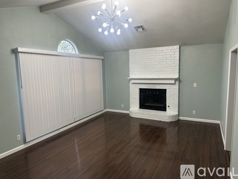 A room with a fireplace and a chandelier.