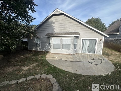 A house with a grey roof and a concrete patio.