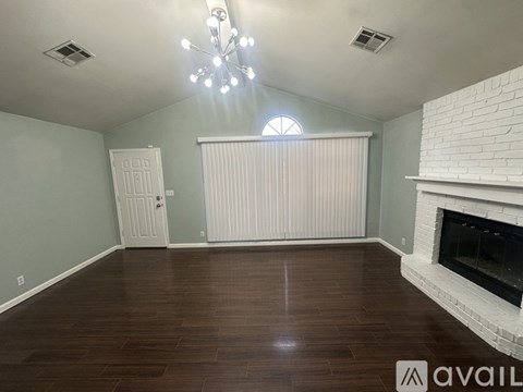 A room with a fireplace and a chandelier.