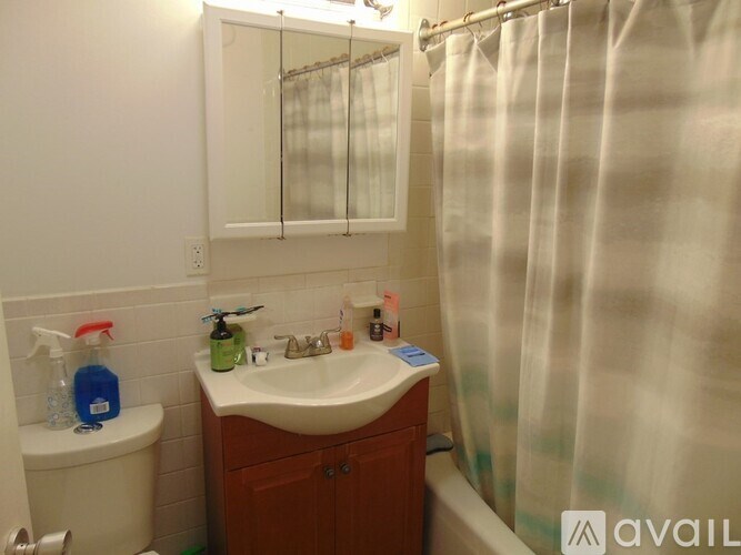 A bathroom with a white sink and a white toilet.