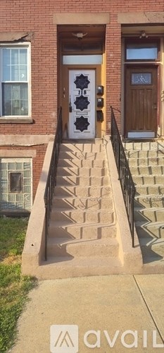 A set of stairs leading to a door with a window on the left.