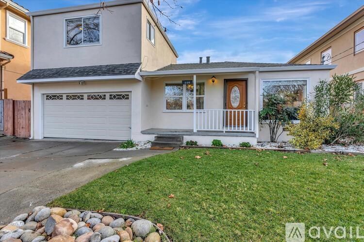 A house with a garage and a front porch is for sale.