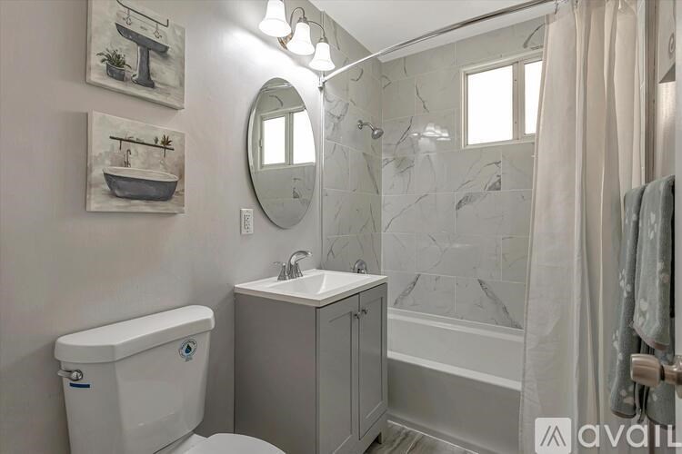A bathroom with a toilet, sink, and shower.