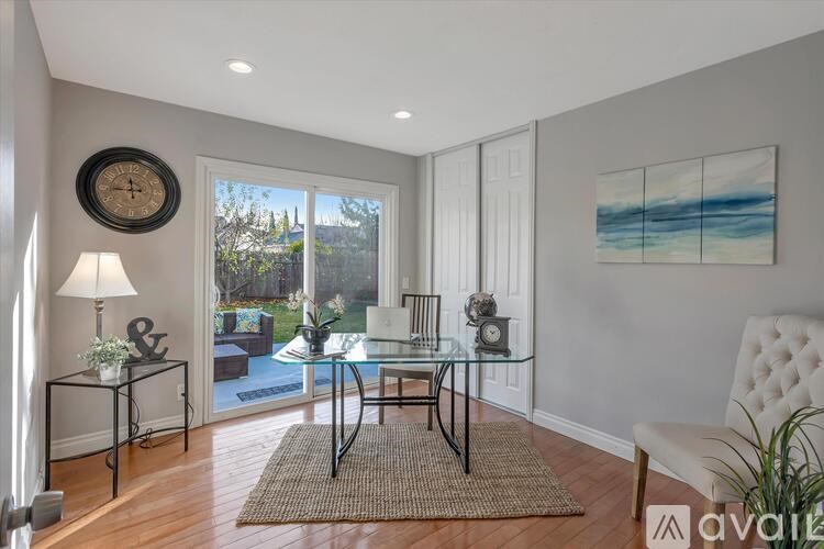 A living room with a glass table and a white couch.