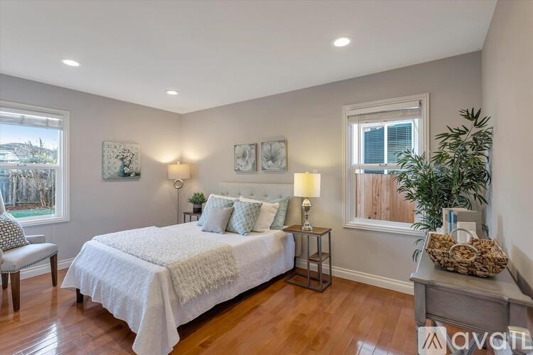 A bedroom with a large bed and a window.