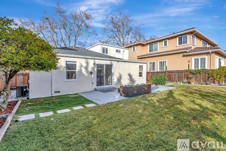 A house with a white garage and a brown house in the background.