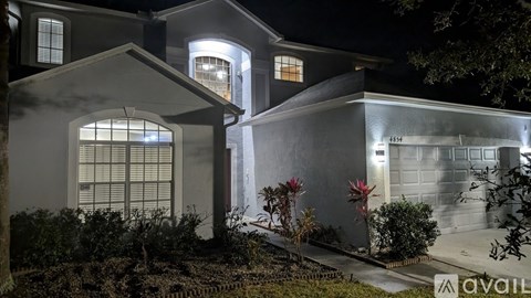 A house with a lit up sign that says "available".