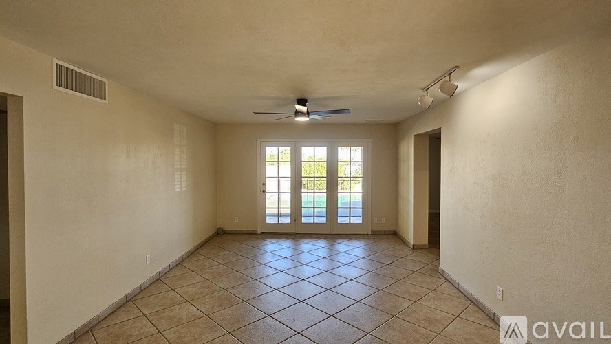 A room with a tiled floor and a ceiling fan.