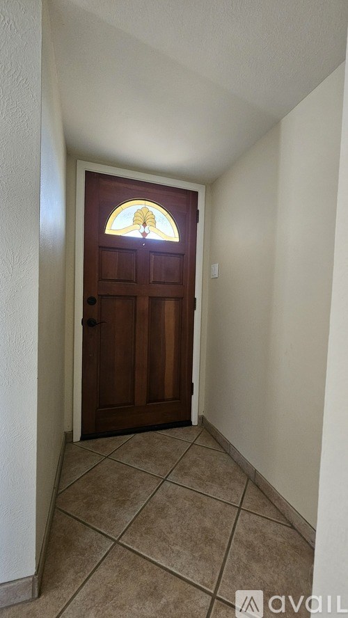 A white closet with shelves and a brown floor.