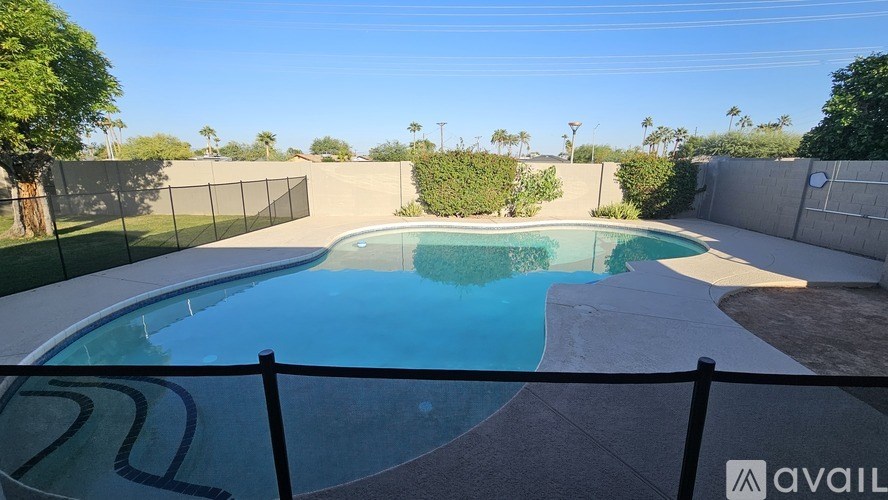 A pool surrounded by a black fence with the word "available" on it.