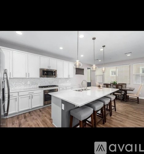 A modern kitchen with white cabinets and a large island.