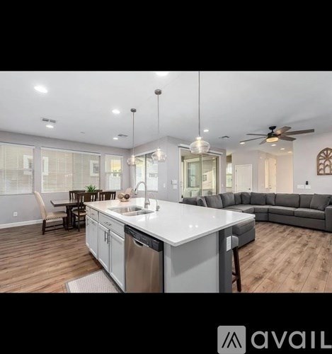 A modern kitchen with a large island and a dining area.