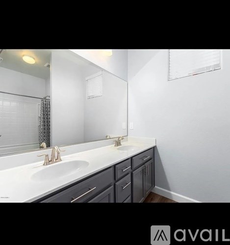 A bathroom with a white sink and a mirror above it.