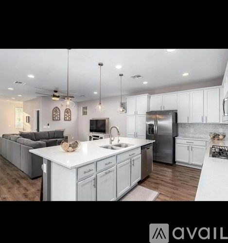 A modern kitchen with white cabinets and a central island.