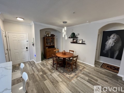 A dining room with a wooden table and chairs.