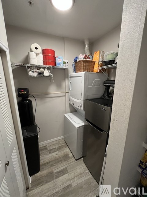 A small kitchen with a refrigerator, dishwasher, and oven.