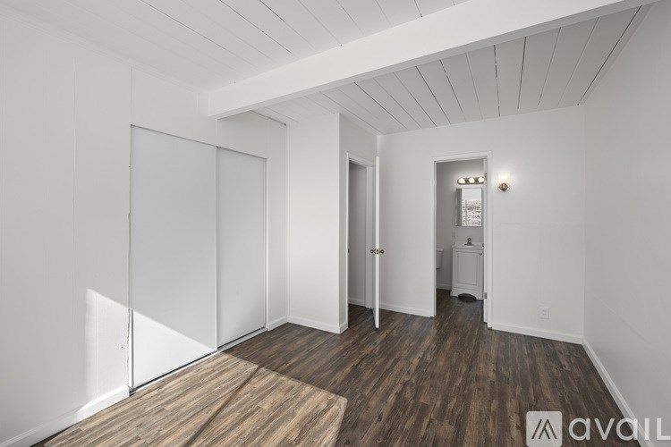 A room with wooden floors and white walls.