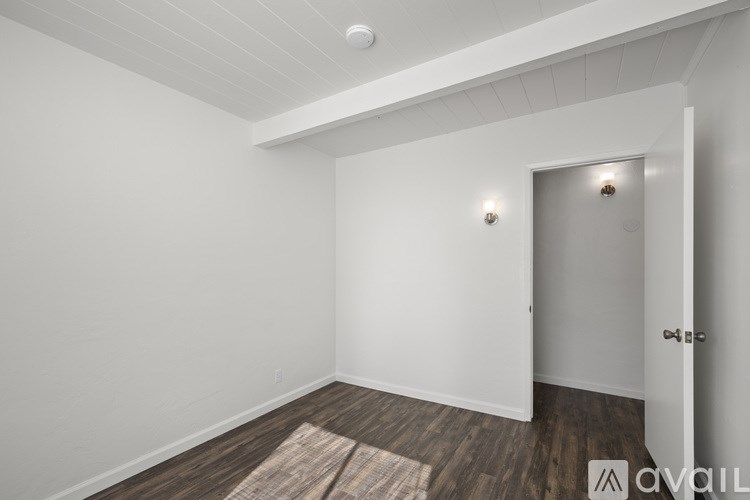 A room with a door and a rug on the floor.