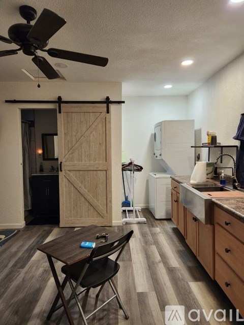A kitchen with a table and chairs in the middle of the room.