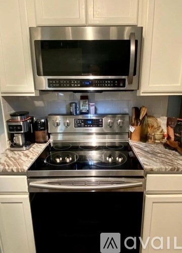 A kitchen with a stove top oven and microwave above it.