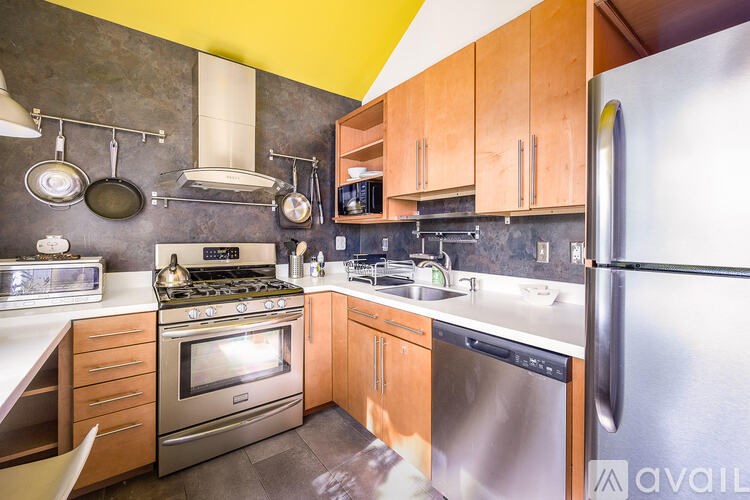 A kitchen with a stove top oven and a refrigerator.