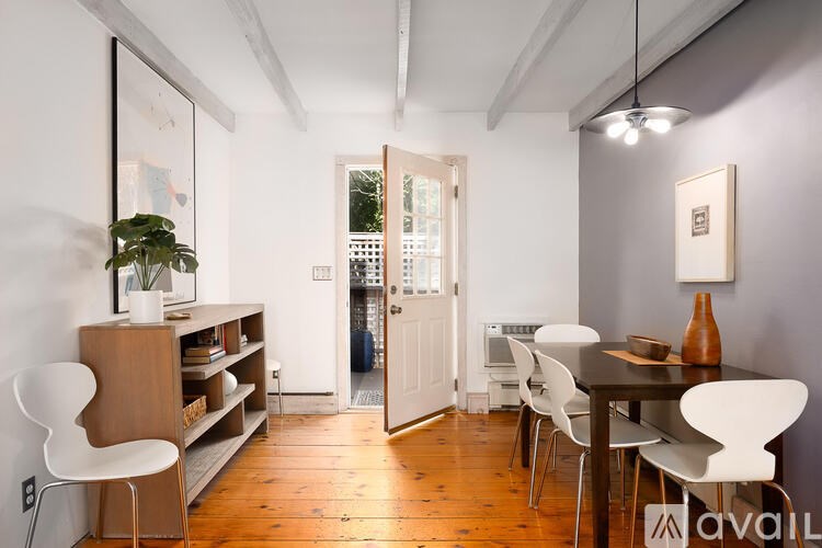 A dining room with a table and chairs.