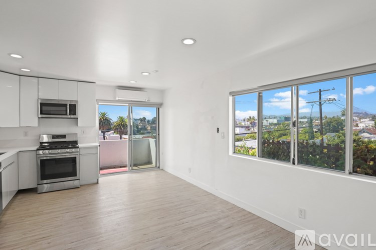 A kitchen with white cabinets and a stainless steel oven.