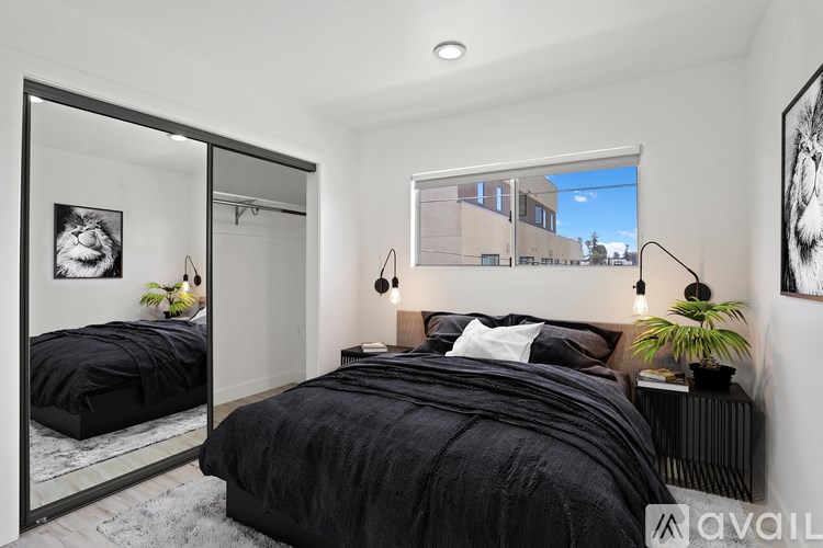 A bedroom with a large bed and a mirror on the wall.