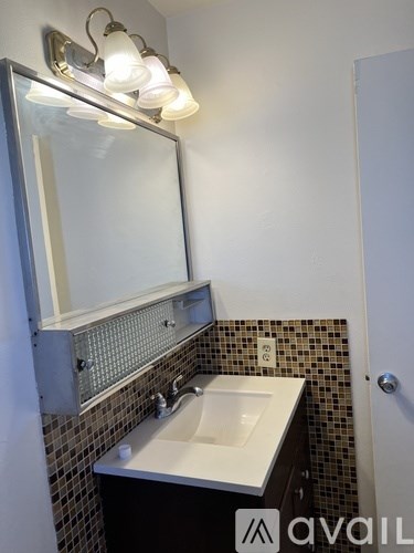 A bathroom with a sink and mirror.
