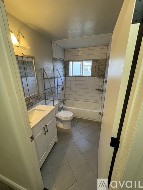 A bathroom with a toilet, sink, and bathtub.