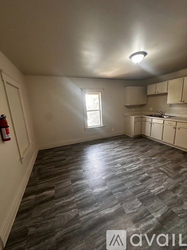 A room with a grey floor and a window.