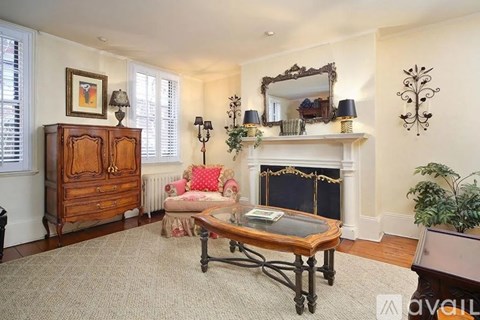 A living room with a fireplace and a mirror on the wall.