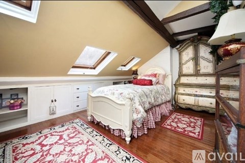 A bedroom with a bed, dresser, and chest of drawers.