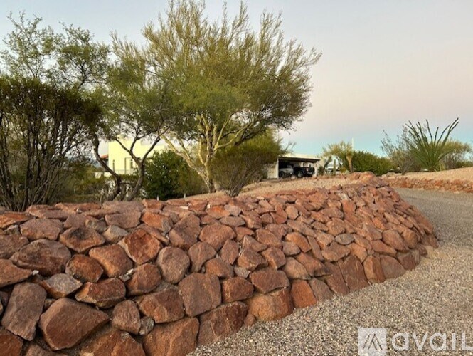 A wall made of stones is in the foreground of the image.