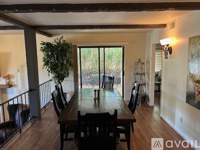 A dining room with a wooden table and chairs.