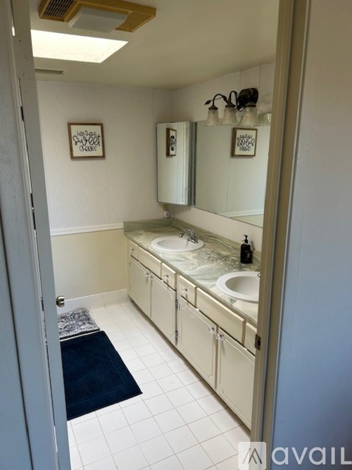 A bathroom with a sink and mirror.