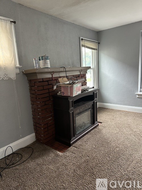 A room with a fireplace and a window.