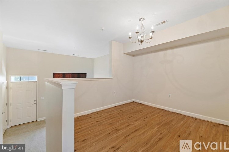 A room with wooden floors and a chandelier.