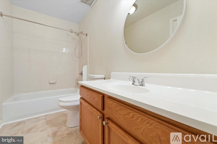 A bathroom with a toilet, sink, and a shower.