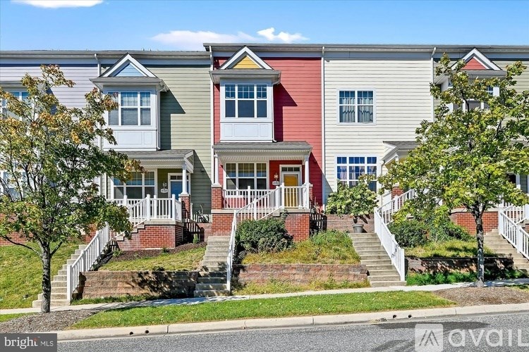 A row of houses with a red, white and grey exterior.