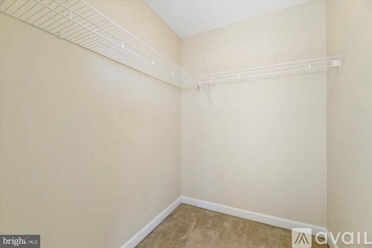 Empty room with a white shelf on the wall.
