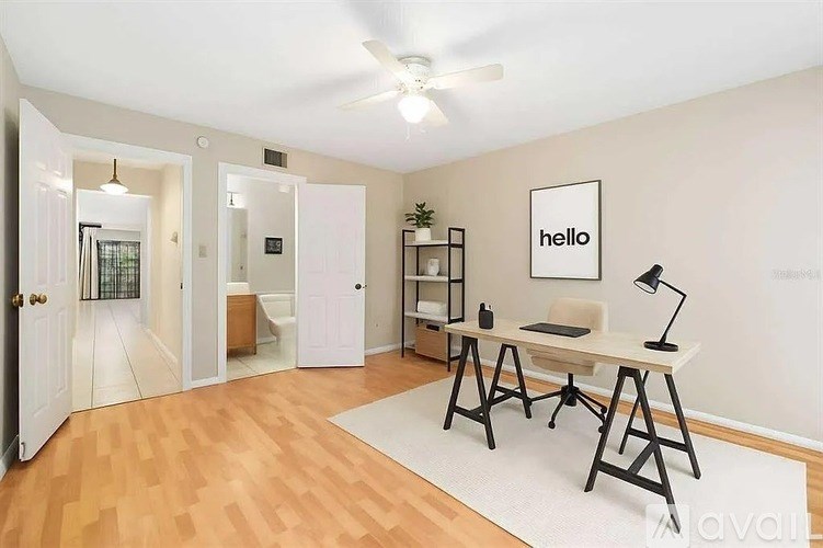 A room with a desk and a chair in it.